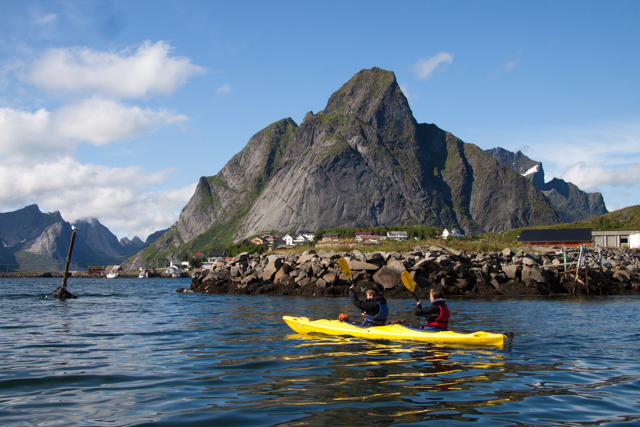Sea kayaking in a sheltered Lofoten channel beneath the peaks